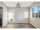 Dining room with gray vinyl flooring, modern light, and pet door at 550 W Ramos Dr, Casa Grande, AZ 85122