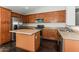 Modern kitchen with wood cabinets, stainless steel appliances and an island at 34831 N Mashona Trl, San Tan Valley, AZ 85143