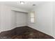 Spacious bedroom with dark stained concrete floors and a window at 34831 N Mashona Trl, San Tan Valley, AZ 85143