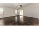 Living room with sliding glass doors, high ceilings, and dark stained concrete floors at 34831 N Mashona Trl, San Tan Valley, AZ 85143