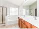 Main bathroom with double sinks, a bathtub, and a shower at 34831 N Mashona Trl, San Tan Valley, AZ 85143