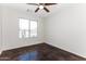 Well-lit bedroom with stained concrete floors and a window at 34831 N Mashona Trl, San Tan Valley, AZ 85143