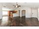 Bright living room with high ceilings, ceiling fan, and dark stained concrete floors at 34831 N Mashona Trl, San Tan Valley, AZ 85143