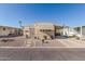 Tan colored manufactured home with carport and landscaping at 2650 W Union Hills Dr # 184, Phoenix, AZ 85027