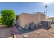 Tan colored manufactured home with AC unit and side yard at 2650 W Union Hills Dr # 184, Phoenix, AZ 85027