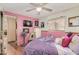 Bedroom with purple bedding and flat-screen TV at 2650 W Union Hills Dr # 184, Phoenix, AZ 85027