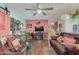 Living room with a brown leather couch, wood floors and ceiling fan at 2650 W Union Hills Dr # 184, Phoenix, AZ 85027