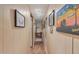 Bright hallway with wood floors and framed artwork at 2650 W Union Hills Dr # 184, Phoenix, AZ 85027