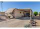 Tan manufactured home with carport and landscaping at 2650 W Union Hills Dr # 184, Phoenix, AZ 85027