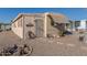 Tan colored manufactured home with stone pathway and landscaping at 2650 W Union Hills Dr # 184, Phoenix, AZ 85027