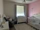 Bedroom with crib, dresser, and comfortable chair at 15240 N 142Nd Ave # 1056, Surprise, AZ 85379