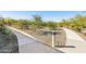 Well-maintained pathways wind through a landscaped community with gravel and drought-tolerant plants at 5827 E Rose Garden Ln, Phoenix, AZ 85054