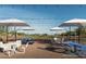 Relaxing patio area with tables, umbrellas, and string lights at 2445 W Rowel Rd, Phoenix, AZ 85085