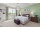 Spacious bedroom with large bed, window and green accent wall at 18191 W Cielo Grande Ave, Surprise, AZ 85387