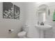 Modern bathroom with pedestal sink, toilet and shiplap walls at 18191 W Cielo Grande Ave, Surprise, AZ 85387