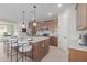 Modern kitchen with island, stainless steel appliances, and ample cabinet space at 18191 W Cielo Grande Ave, Surprise, AZ 85387