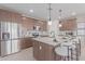 Modern kitchen with island, stainless steel appliances, and ample cabinet space at 18191 W Cielo Grande Ave, Surprise, AZ 85387