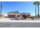 House exterior with a two-car garage and flowering bushes at 19803 N Desert Song Ct, Surprise, AZ 85374