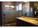 Bathroom with double vanity, large mirror, and walk-in shower at 1750 W Union Hills Dr # 77, Phoenix, AZ 85027