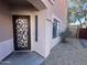 Side entrance of the house with decorative metal door and gravel at 1750 W Union Hills Dr # 77, Phoenix, AZ 85027