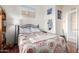 Cozy bedroom with floral bedding and built-in shelving at 8500 E Southern Ave # 575, Mesa, AZ 85209