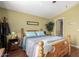 Well-lit bedroom with a wooden bed frame and an ensuite bathroom at 8500 E Southern Ave # 575, Mesa, AZ 85209