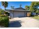 Single-story home with a two-car garage and mature landscaping at 10423 W Wheatridge Dr, Sun City, AZ 85373