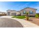 Modern home exterior with a three-car garage and artificial turf at 5170 N 186Th Dr, Litchfield Park, AZ 85340