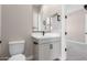 Modern bathroom with single vanity, white cabinets, and black accents at 5170 N 186Th Dr, Litchfield Park, AZ 85340