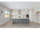Modern kitchen with gray island and white cabinets at 5170 N 186Th Dr, Litchfield Park, AZ 85340