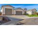 Modern home exterior with a three-car garage and artificial turf at 5170 N 186Th Dr, Litchfield Park, AZ 85340