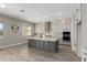 Bright kitchen features a large island, stainless steel appliances, and tile backsplash at 5170 N 186Th Dr, Litchfield Park, AZ 85340