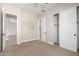 Spacious bedroom with carpet, two closets, and doors to other areas at 5170 N 186Th Dr, Litchfield Park, AZ 85340