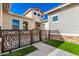 Landscaped front yard with a decorative iron gate and walkway at 5170 N 186Th Dr, Litchfield Park, AZ 85340