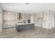 Spacious kitchen with an island, stainless steel appliances, and light wood-look flooring at 5170 N 186Th Dr, Litchfield Park, AZ 85340