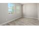 Bright bedroom with wood-look floors and two large windows at 5170 N 186Th Dr, Litchfield Park, AZ 85340