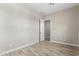 Light and airy bedroom with wood-look floors and access to another room at 5170 N 186Th Dr, Litchfield Park, AZ 85340