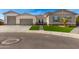 Modern home exterior with a three-car garage and artificial turf at 5170 N 186Th Dr, Litchfield Park, AZ 85340