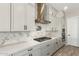 Modern kitchen with white cabinets, gas cooktop, and stylish backsplash at 5170 N 186Th Dr, Litchfield Park, AZ 85340