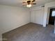 Bright bedroom featuring neutral walls, carpeting, and sliding mirrored closet doors at 3500 N Hayden Rd # 1903, Scottsdale, AZ 85251