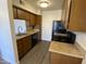 Simple kitchen with wood cabinets and appliances at 3500 N Hayden Rd # 1903, Scottsdale, AZ 85251