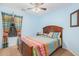 Bedroom with wood framed bed and colorful bedding at 1595 W Agrarian Hills Dr, San Tan Valley, AZ 85144