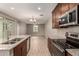 Open kitchen with stainless steel appliances and view of living room at 2772 S Betty St, Gilbert, AZ 85295
