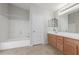 Bathroom with tub, double vanity, and wood cabinets at 355 W Jersey Way, San Tan Valley, AZ 85143