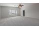 Bright bedroom featuring carpeted floor and large window at 355 W Jersey Way, San Tan Valley, AZ 85143