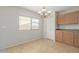 Bright dining area with a chandelier and adjacent kitchen access at 355 W Jersey Way, San Tan Valley, AZ 85143