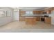 Modern kitchen with light wood cabinets, an island, and stainless steel appliances at 355 W Jersey Way, San Tan Valley, AZ 85143