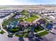 Aerial view of The Algarve community, including a clubhouse, pool, and park at 856 E Harmony Way, San Tan Valley, AZ 85140