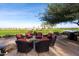 Stone patio with fire pit and seating overlooking golf course at 856 E Harmony Way, San Tan Valley, AZ 85140