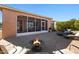 Relaxing backyard patio with fire pit, screened enclosure, lounge chairs, and desert landscaping at 856 E Harmony Way, San Tan Valley, AZ 85140